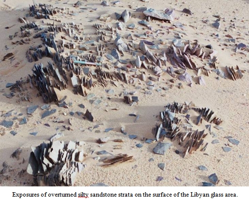 Exposures of overturned silty sandstone strata on the surface of the Libyan glass area.